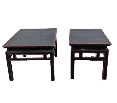 a pair of chinese style tables with black tops
