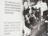 an open book with a black and white photo of people on a train track