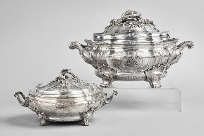 a pair of silverplated dishes and covers on stands