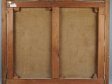 an old wooden frame with two open doors on a wall