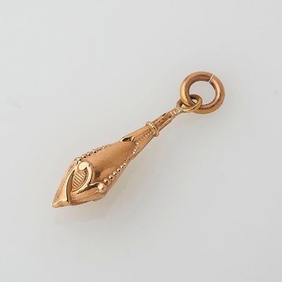 an image of a gold plated pendant with a fish on it