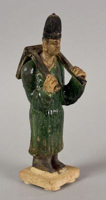 figurine of a man holding a baseball bat on a base