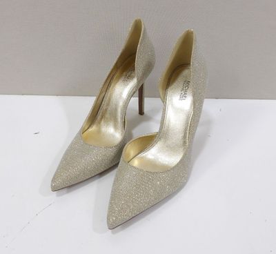 a pair of women ' s silver heels on a white surface