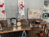 a table with a clock, vases, and other items on it