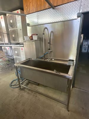 un grand évier en inox au milieu d'une cuisine