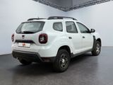 a white car that is parked inside of a building