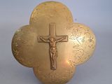 une croix en or surmontée d'un crucifix