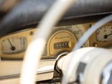 dashboard of an old car with gauges and a steering wheel