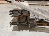 several pieces of metal are stacked on top of each other in a warehouse