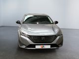 the front view of a silver car parked in a showroom