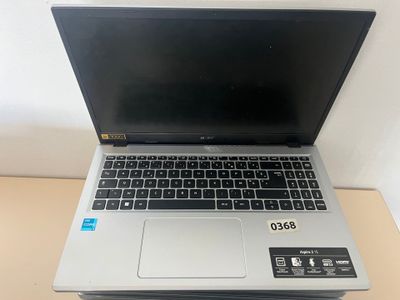 an open laptop computer sitting on top of a wooden table