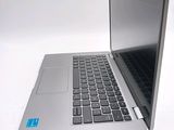 a silver laptop with a blue sticker on the screen