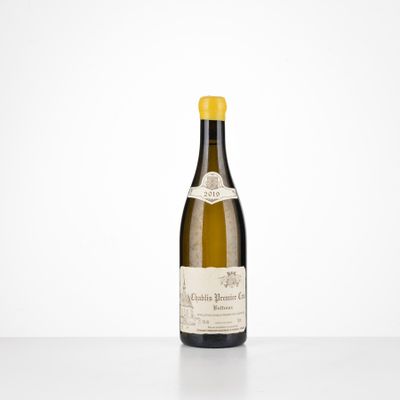 a bottle of wine sitting on top of a white table