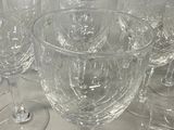 many empty wine glasses lined up on a table