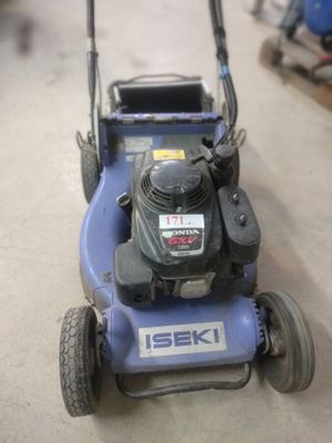 a blue lawn mower sitting on the floor in the garage