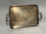 two silver trays with handles and handles on a white surface