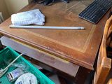 a desk with a computer, keyboard, mouse, and other items on it