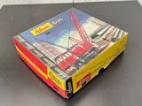 a box with a picture of a crane on it on a table