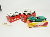three toy cars are sitting on top of a box of boxes