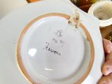 a person holding a white plate with writing on it