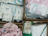 boxes filled with baby clothes and diapers sitting on top of a table