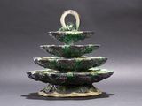 a picture of a green and white fountain on a gray background