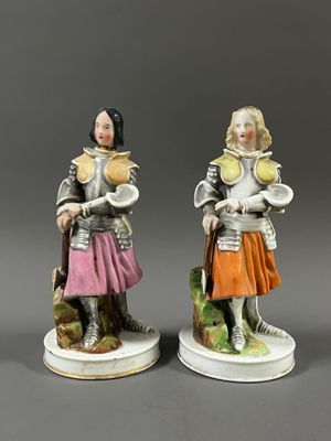 pair of figurines of a knight and a lady in armor