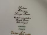 a white plate with a black and gold design on it
