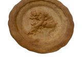 a clay plate with a picture of a man on it