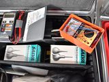 a suitcase with many items in it and a laptop