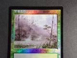 a close up of a card with a picture of a river in the background