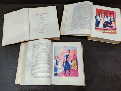 three open books on a table with pictures of a man and a woman