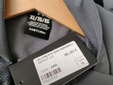 the back of a gray jacket with a tag on a hanger