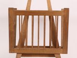 a wooden magazine rack with a magazine holder on it
