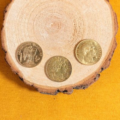 three coins sitting on top of a piece of wood