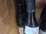 several bottles of wine sit on a shelf in a wine cellar