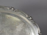 a silver tray with a handle on a table
