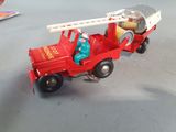 a toy fire truck with a ladder and a fire hydrant in the back