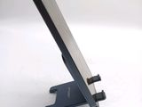 a cell phone sitting on a stand on a white surface