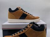 a pair of brown and black sneakers on top of a box