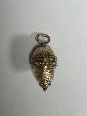 an image of a small gold bell hanging on a white wall