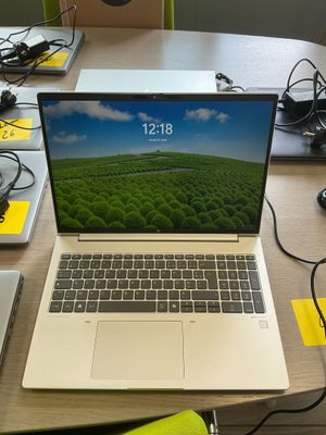 a laptop that is sitting on a desk with other electronics