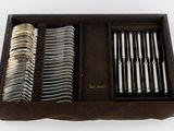 many forks and spoons in a box on the table