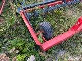 a red lawn mower that is laying in the grass