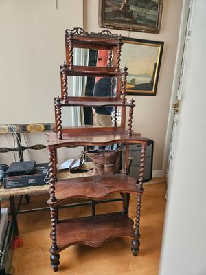a wooden shelf with a mirror on it in a living room