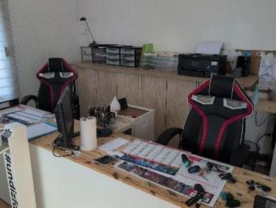a desk with a chair and a computer on it
