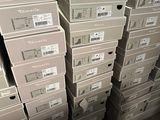 several stacks of boxes stacked on top of each other in a warehouse
