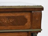 a close up of a wooden cabinet with a marble top