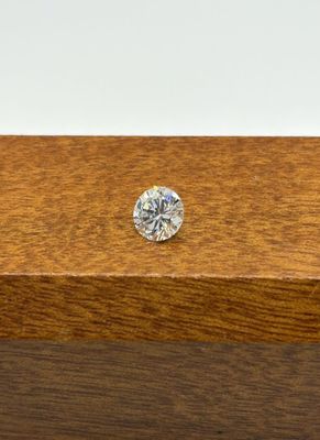 a close up of a diamond sitting on top of a wooden box