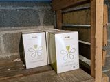 two boxes sitting on a wooden shelf in a room